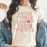 Alphabet I Love You Graphic Tee | Faux Chenille | Fri-Yay Teacher | School | Valentines |  I Heart You | Pink | Printed Tee | Laying Tee